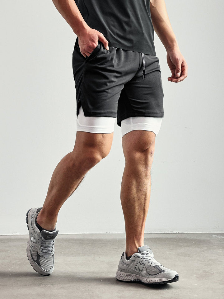Stack of men's Kinetic mesh shorts in various colors, ready for gym & activewear.