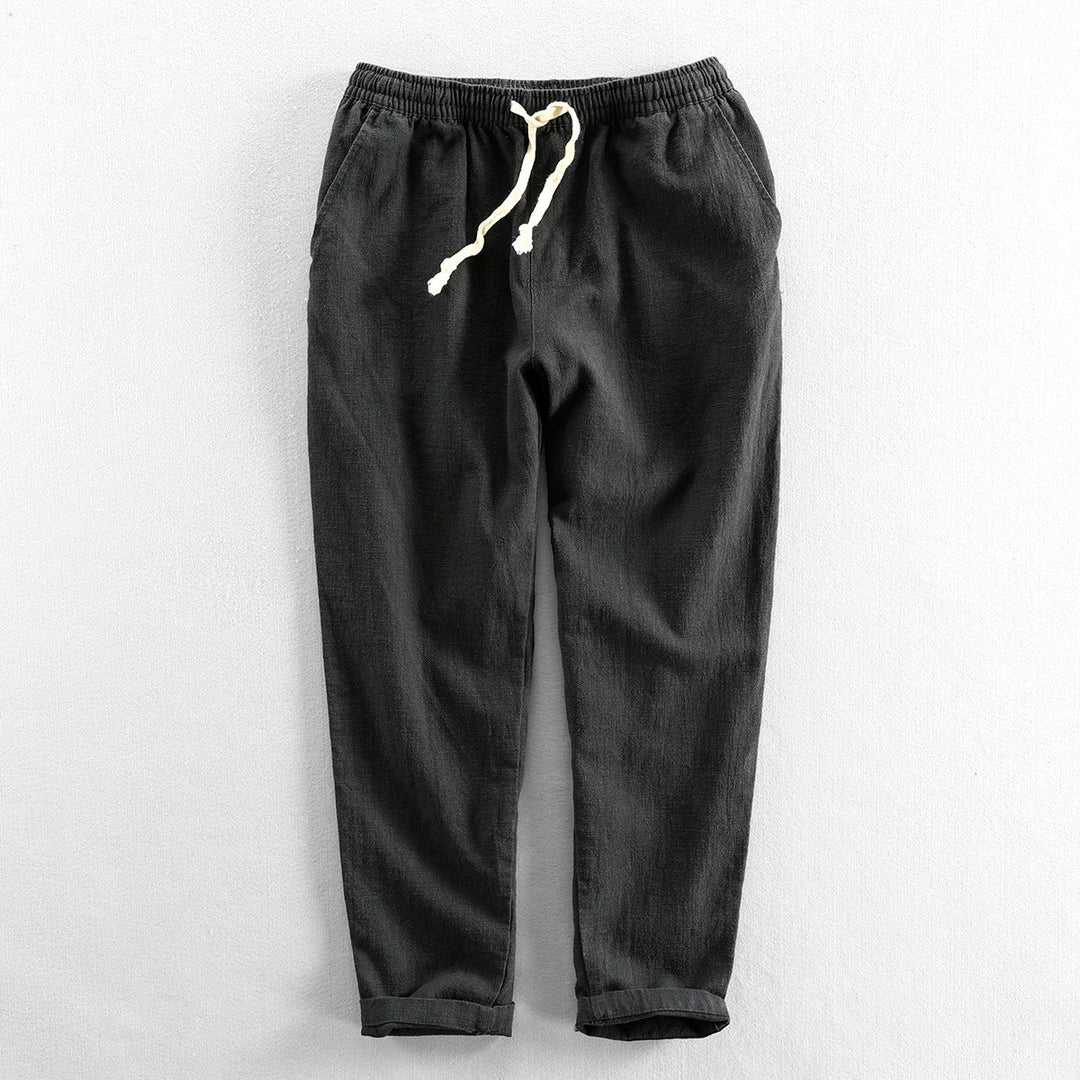 Lightweight men's linen drawstring trousers for a relaxed fit; perfect breathable bottoms for summer.
