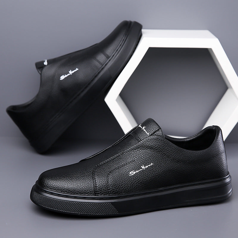 Top-down view of white men's slip-on sneakers, emphasizing their clean lines and modern design.