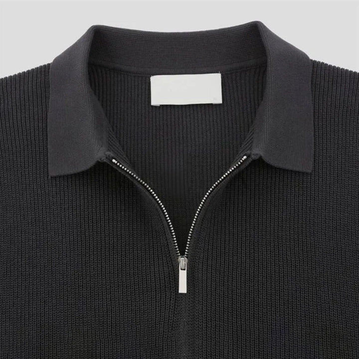 Close-up of men's zip-up polo shirt, tailored fit, showcasing the modern zipper detail and comfortable knit fabric.