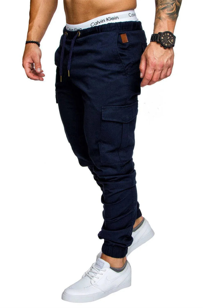 Zoomed shot of the versatile multi-pocket configuration on men's cargo pants, durable fall fashion