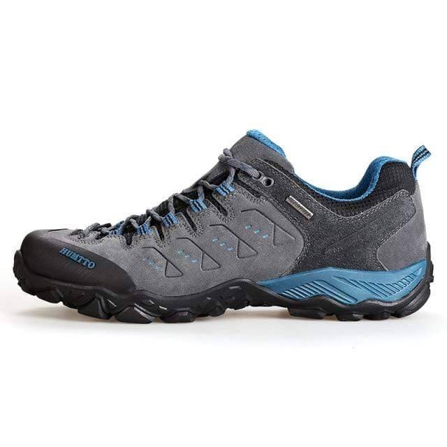 Men's non-slip trail shoes in a natural outdoor setting, highlighting their robust design