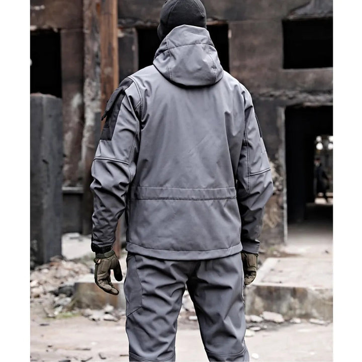 Men's outdoor performance set with multi-pocket hoodie & pants, ideal for hiking and camping adventures.