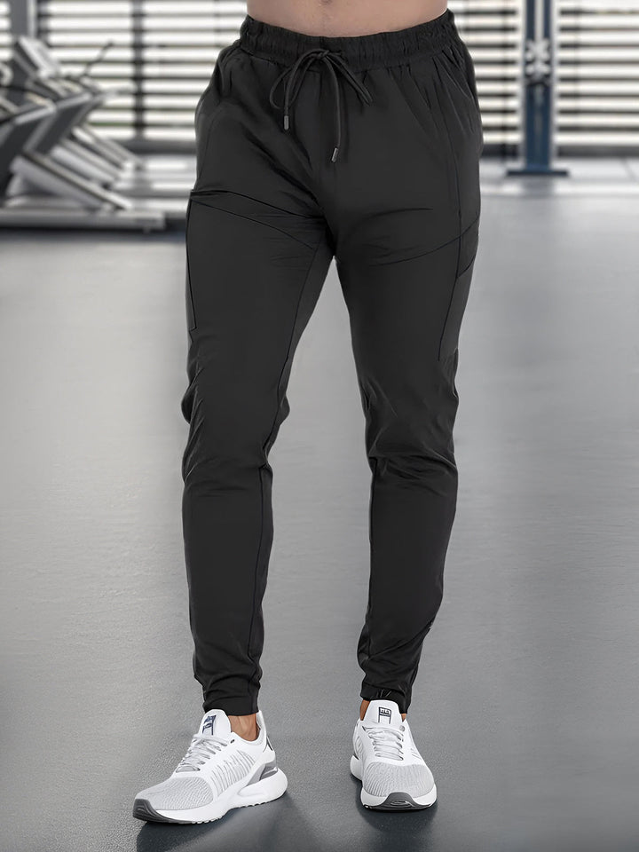 Quick-dry men's joggers, athletic wear, comfortable tapered fit for active lifestyle.