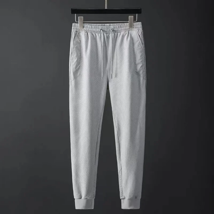 Men's performance hoodie & tapered joggers. Modern techwear tracksuit set designed for comfort & athletic style.