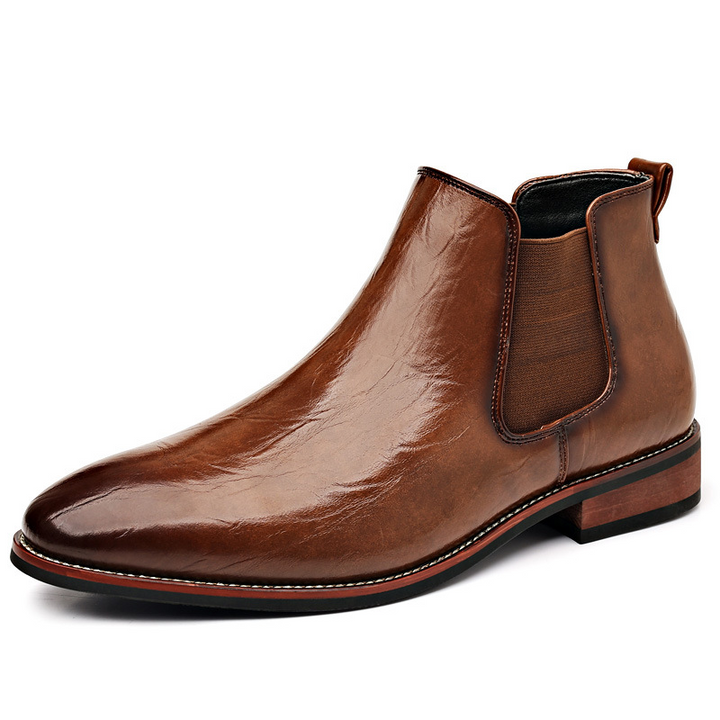 Pair of light brown polished slip-on Chelsea boots, men's comfortable & stylish ankle footwear.