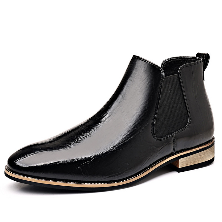 Side view of men's black polished slip-on Chelsea boots, showcasing sleek design & comfort.