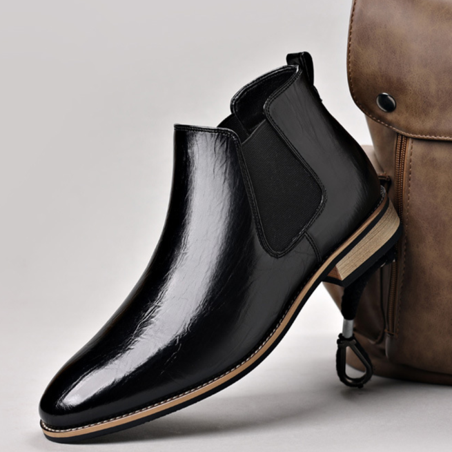 Dark brown men's ankle boots, featuring a polished finish & easy slip-on design for comfort.