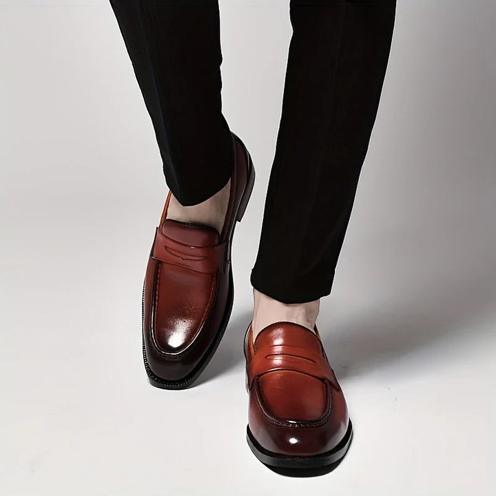 Comfortable men's slip-on loafers with a polished finish, great for dress or casual outfits.