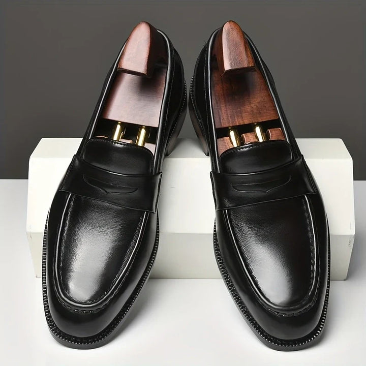 Classic black polished men's loafers, easy slip-on style for ultimate comfort and elegance.