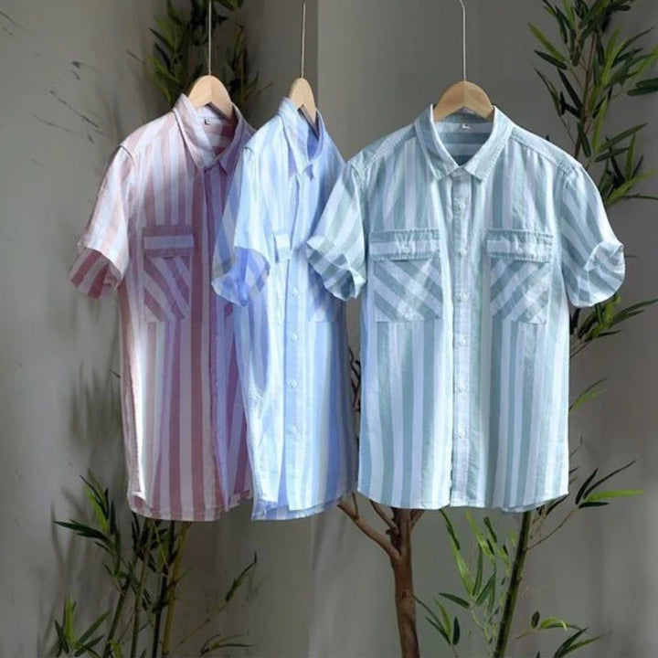 Tailored men's short-sleeve button-up shirt with classic stripes & chest pocket. Perfect for resort and vacation wear.