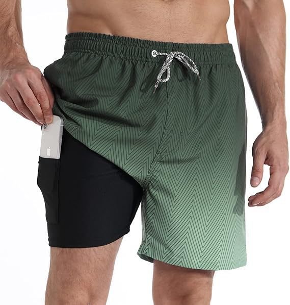 Man wearing vibrant quick-dry swimwear shorts on a sunny beach, enjoying summer water sports.