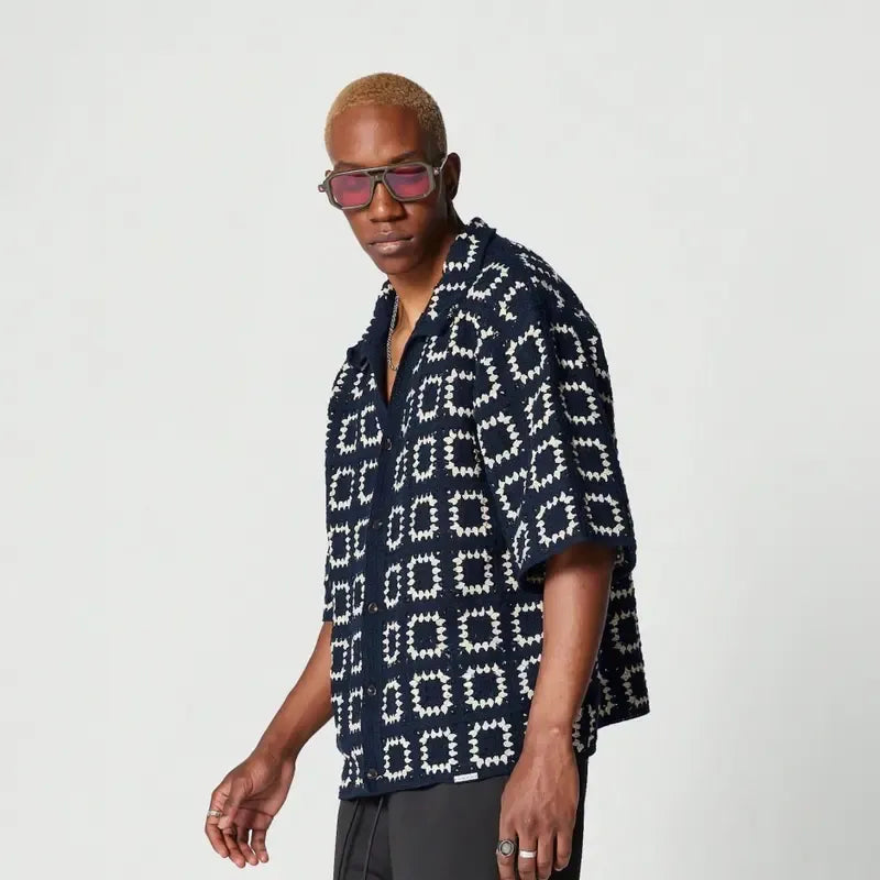 Button-down men's knit shirt, short sleeve, showcasing a distinct geometric texture for a smart casual vibe.