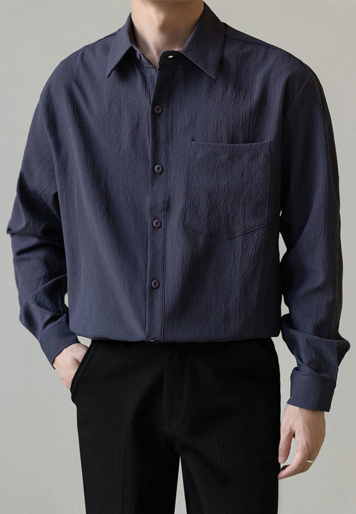 Front view of a men's casual relaxed fit button-up shirt, emphasizing its clean lines & modern style.