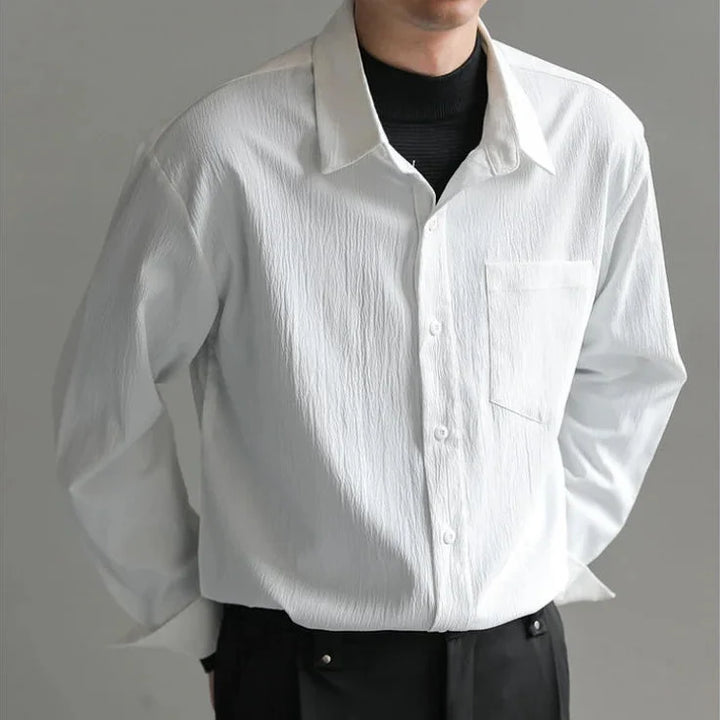 Crisp white men's relaxed fit button-up shirt, essential for modern casual men's style.