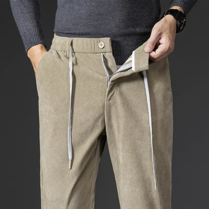 Modern men's apparel: relaxed fit pants with elastic waist & drawstring, suitable for casual everyday style.