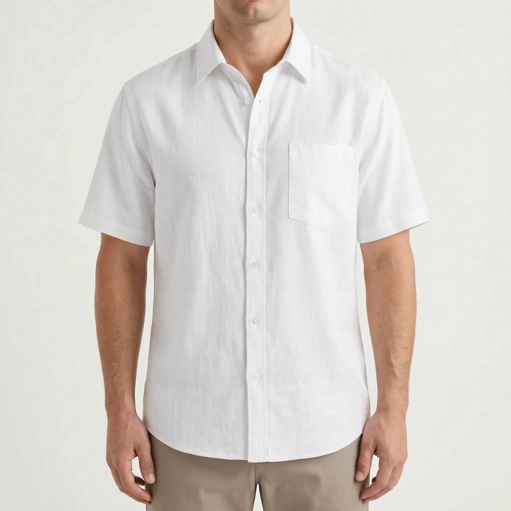A man wearing a relaxed fit short-sleeve button-up shirt, perfect for casual summer warm weather comfort.