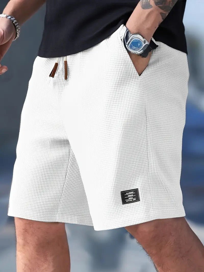 Men's waffle knit texture shorts, relaxed fit, drawstring for comfort & casual summer style.