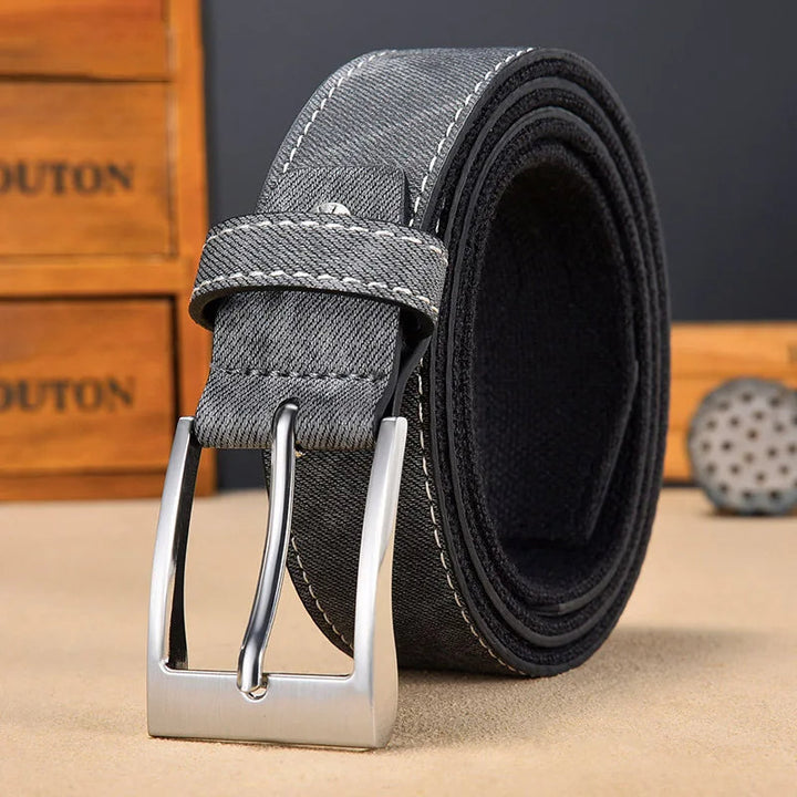 Stylish metal buckle on a men's adjustable reversible belt, complementing both denim and canvas sides.