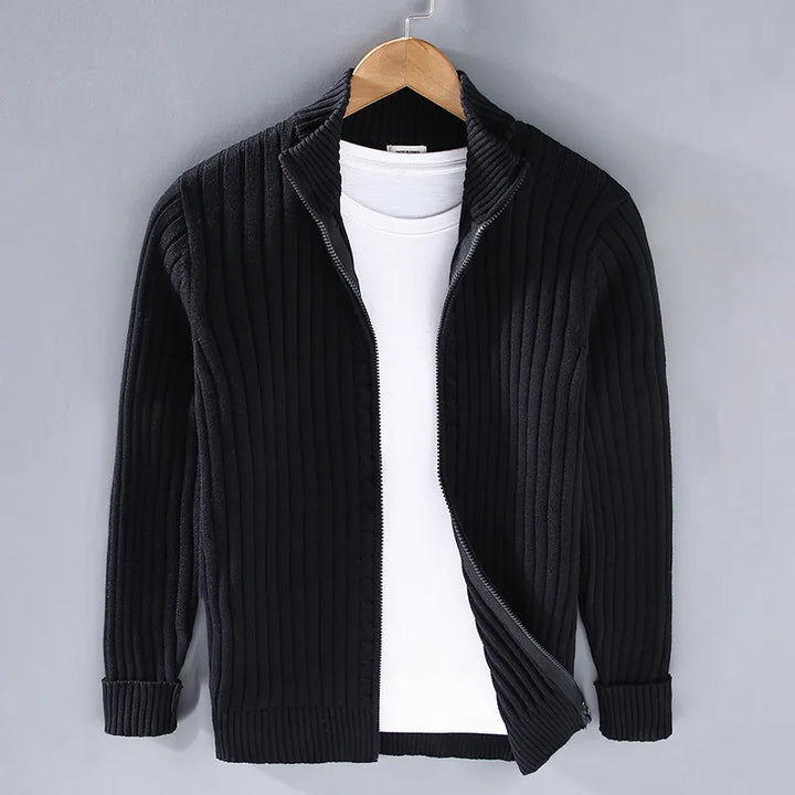 Model in elegant men's full-zip ribbed knit sweater. Classic cotton blend design, perfect for sophisticated layering.