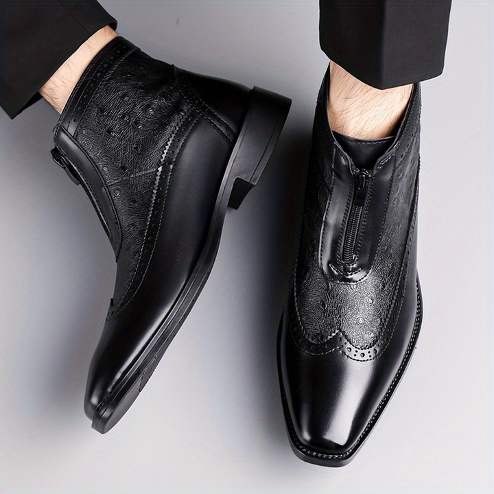 Elegant black men's footwear: front zip ankle boots with a sleek silhouette.