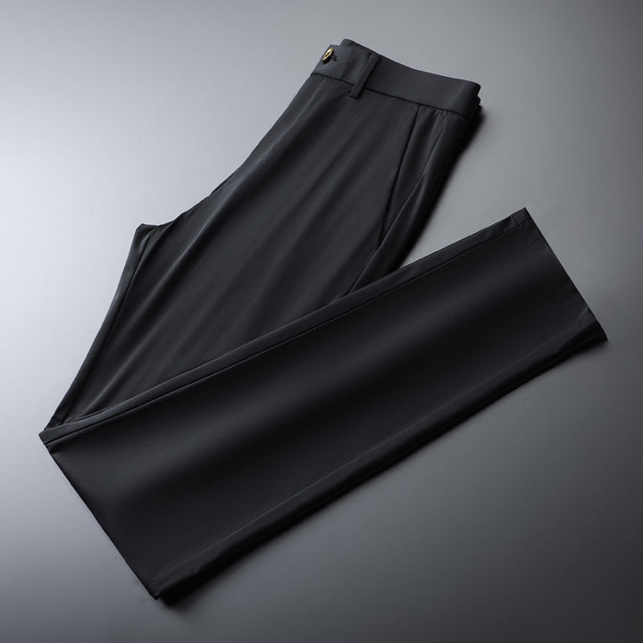 Man relaxing in army green slim fit performance pants, perfect for casual and versatile style.