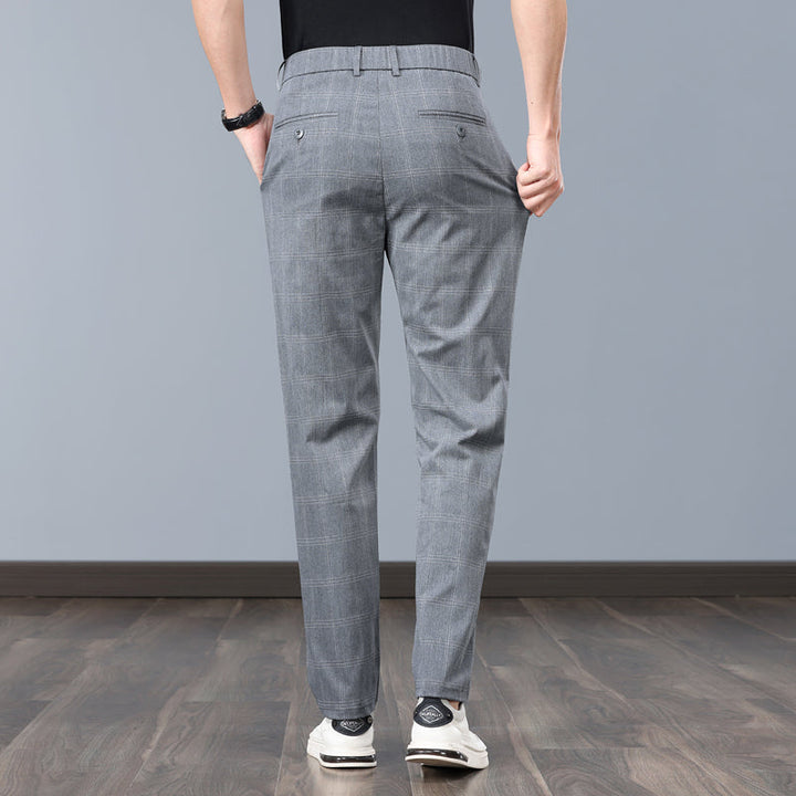 Close-up of men's slim fit plaid dress pants fabric, highlighting quality tailoring and comfort.