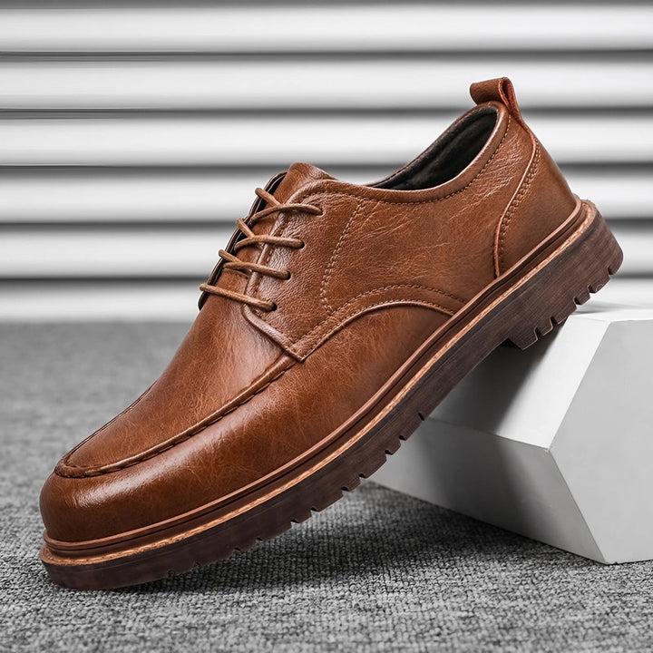 Close-up of men's sleek black classic dress shoes, featuring polished leather finish. Essential formal footwear.