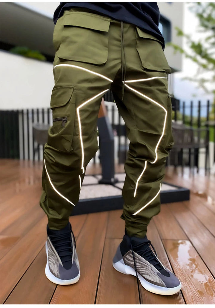 Performance-driven men's cargo joggers with reflective accents, perfect for versatile athletic wear.