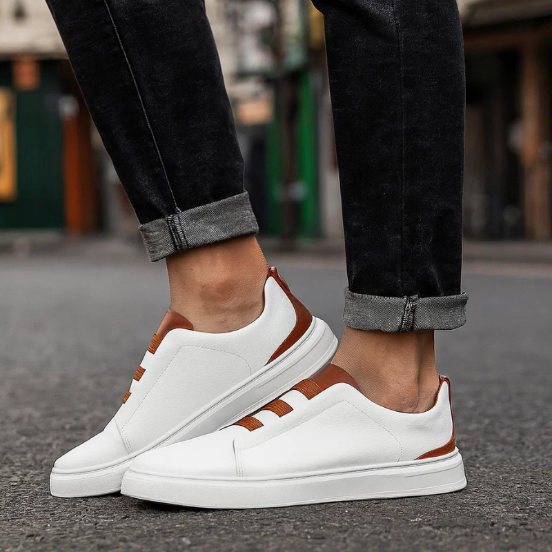 Stylish white Men's Strada slip-on sneakers. Laceless design provides comfort & a clean, casual look for men.