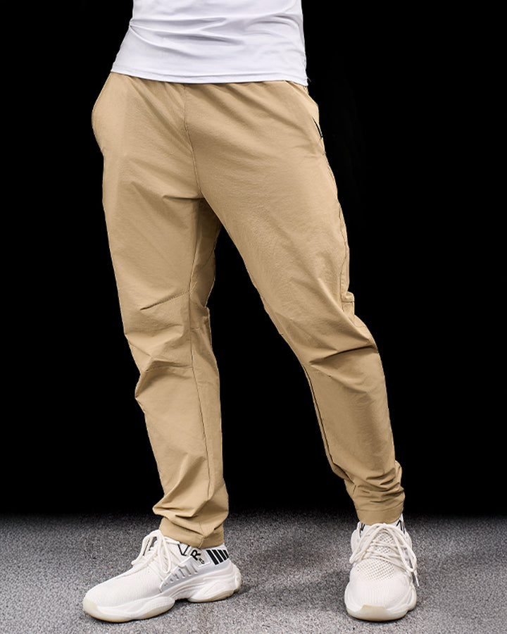 Grey men's flexible stretch adventure pants. Quick-dry, durable outdoor bottoms for travel & hiking.