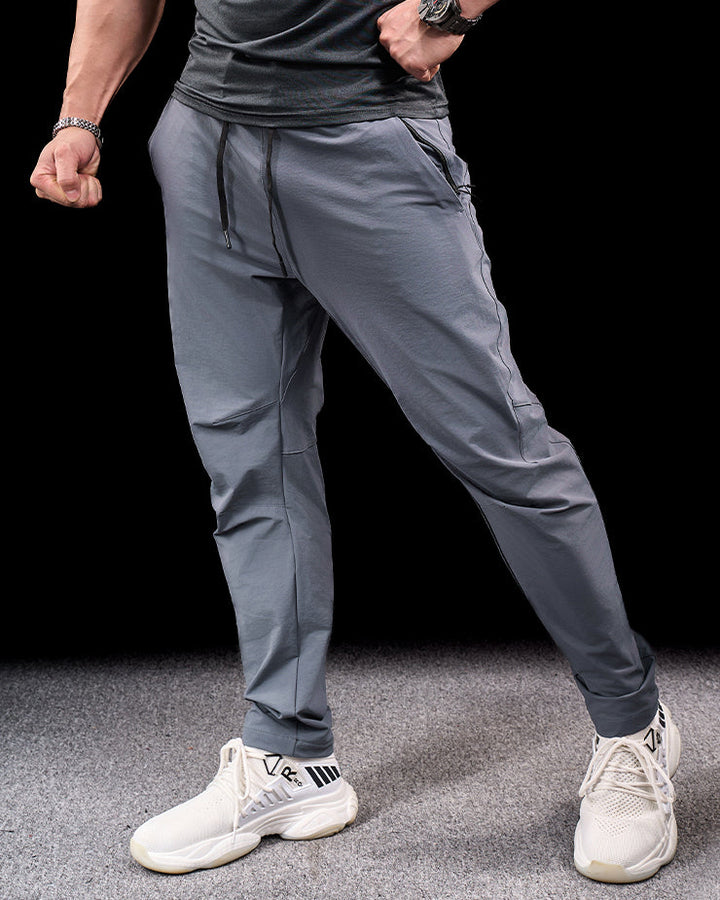 Navy men's quick-dry stretch adventure pants. Flexible activewear bottoms for hiking & travel.