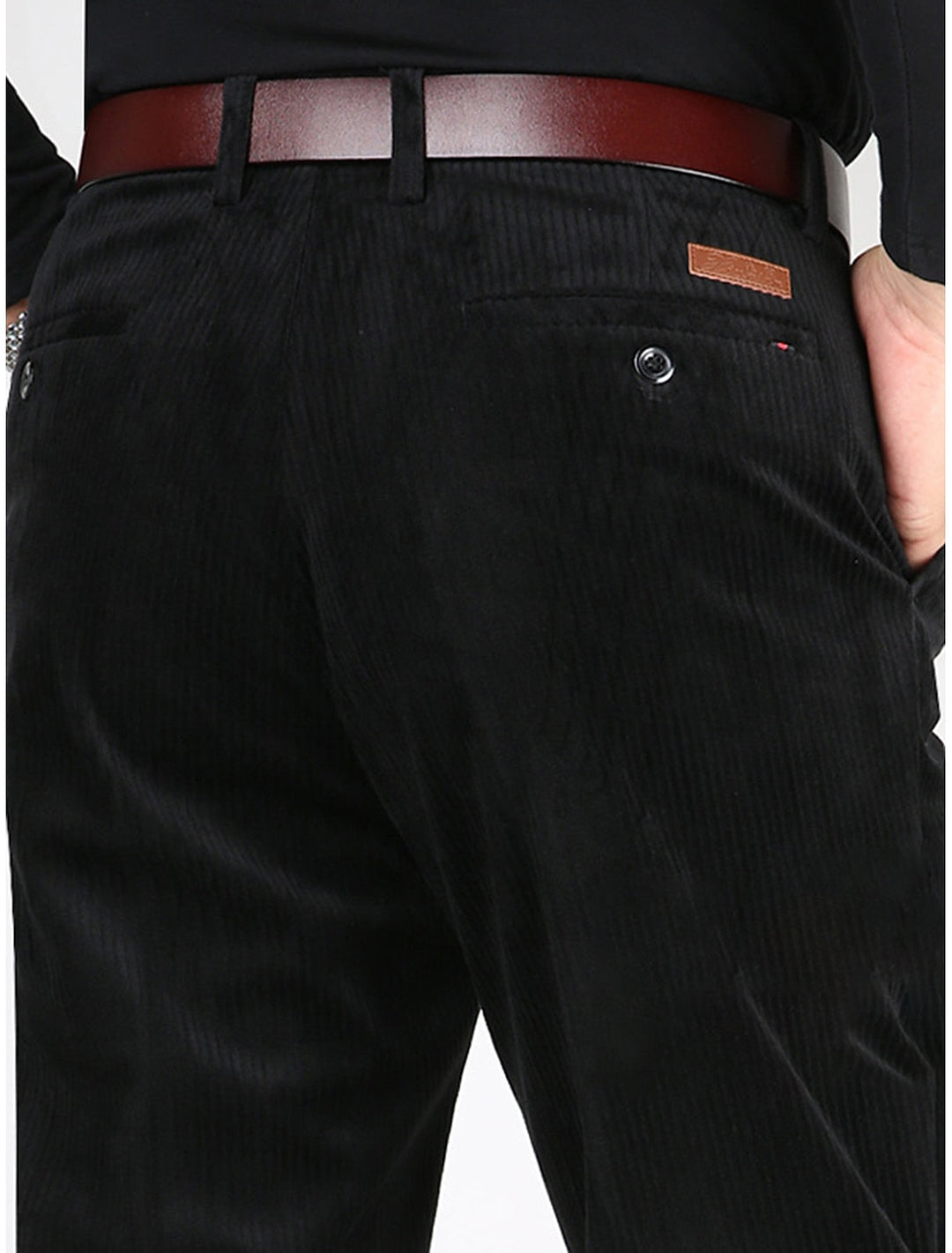 Close-up of men's structured ribbed trousers fabric, showing textured pattern and quality for modern comfort.