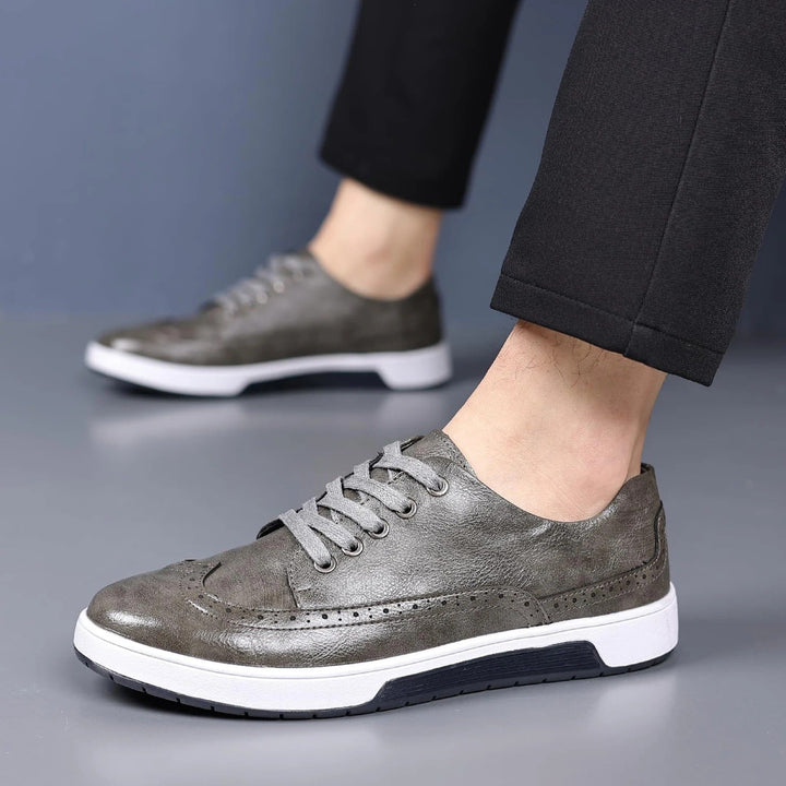 Classic men's brogue sneakers with intricate detailing, versatile for dress or casual wear. Comfortable footwear.