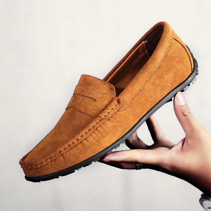 Classic black men's loafers, comfortable & versatile for dress or casual outfits.