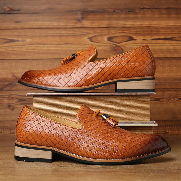 Stylish men's woven tassel loafers in a dark shade, perfect for formal and elegant occasions.