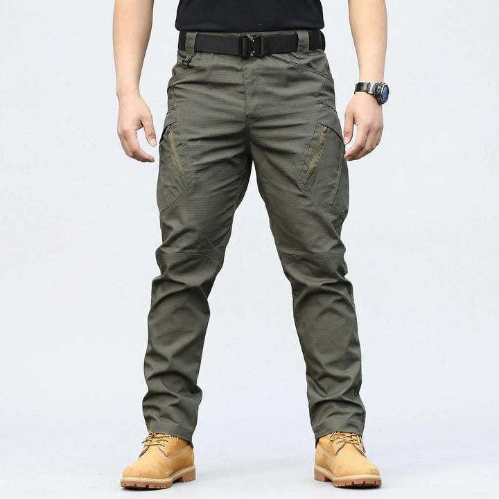 Rugged men's multi-pocket tactical cargo pants with 9 storage pockets, perfect adventure gear for outdoor activities.