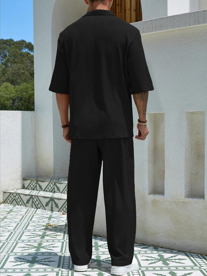 Men's matching lounge set with a unique textured design. Two-piece comfort in a relaxed fit for stylish home wear.