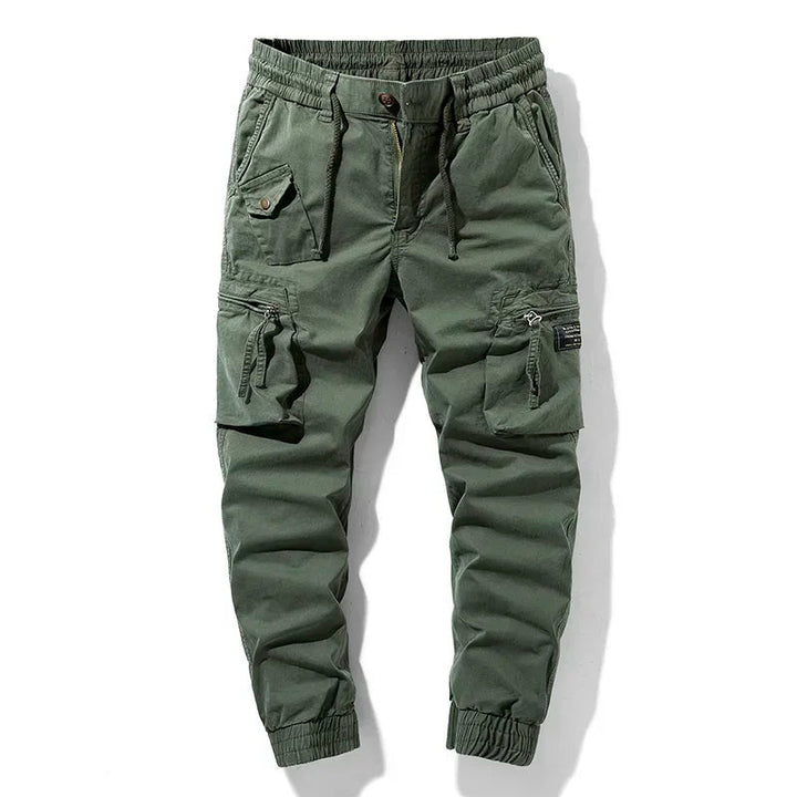 Men's Trekform cargo utility jogger pants in gray, green, or khaki. Tapered fit for active comfort.