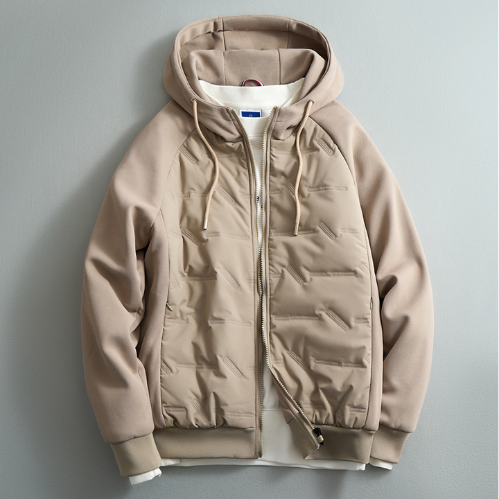 Man models ultimate puffer hoodie, showcasing its warmth & stylish fit for modern winter fashion and casual wear.