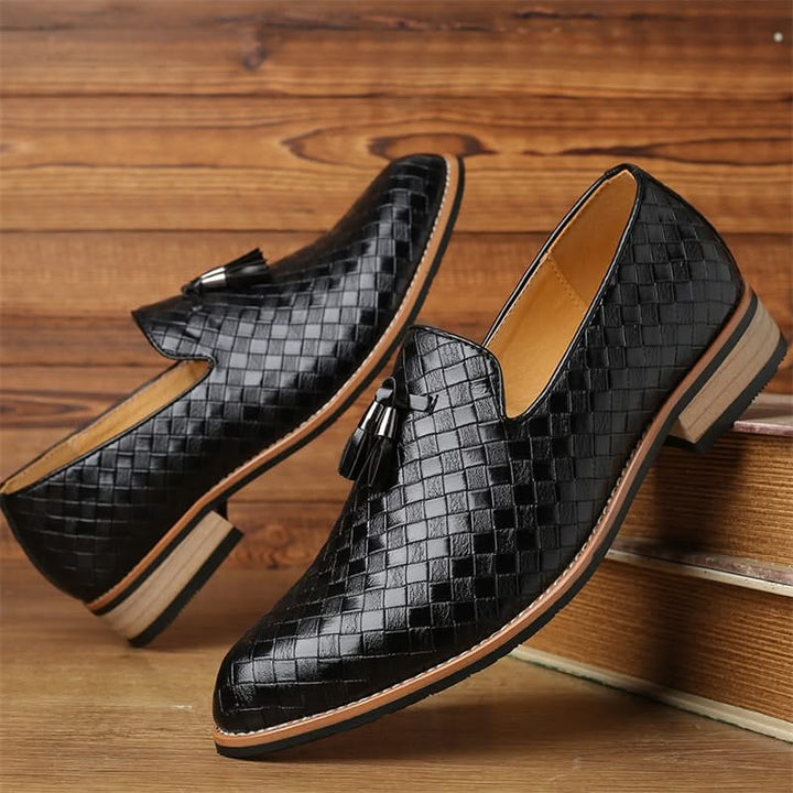 Classic men's slip-on tassel loafers. Brown woven texture, formal yet comfortable footwear.