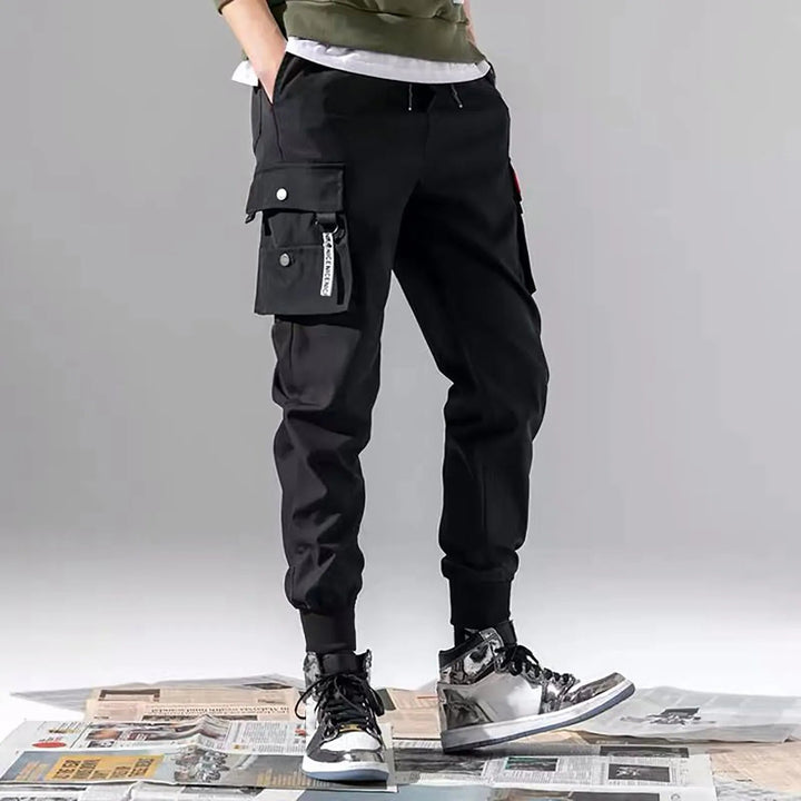 Versatile men's tapered cargo joggers in stealth black. Ideal for streetwear, casual or active comfort.