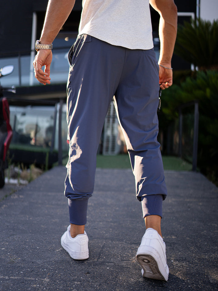 Dynamic shot: Men's performance cargo joggers, showing flexibility for active pursuits.