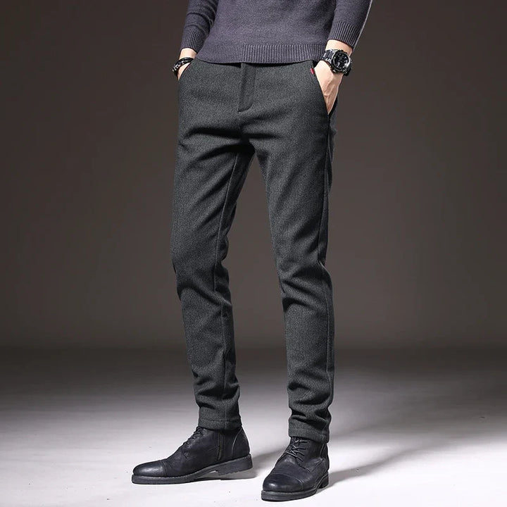 Black men's tailored stretch pants, offering a sleek slim fit for versatile occasions.