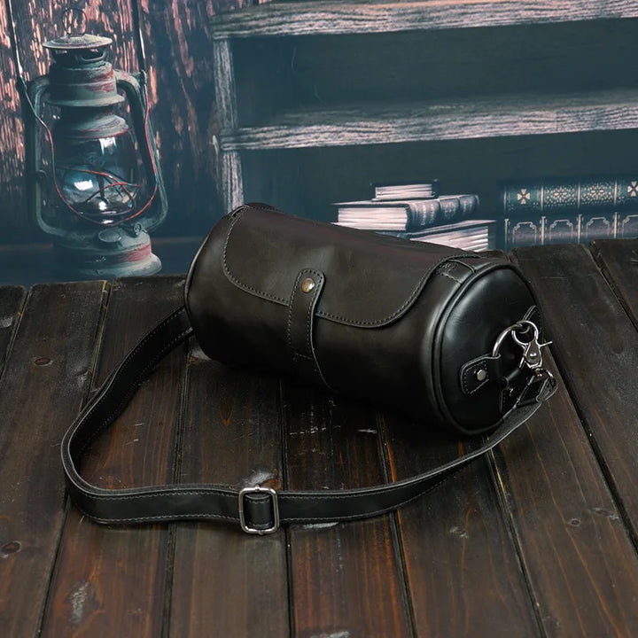 Durable men's vintage barrel shoulder bag for travel. PU leather cross-body accessory, stylish.