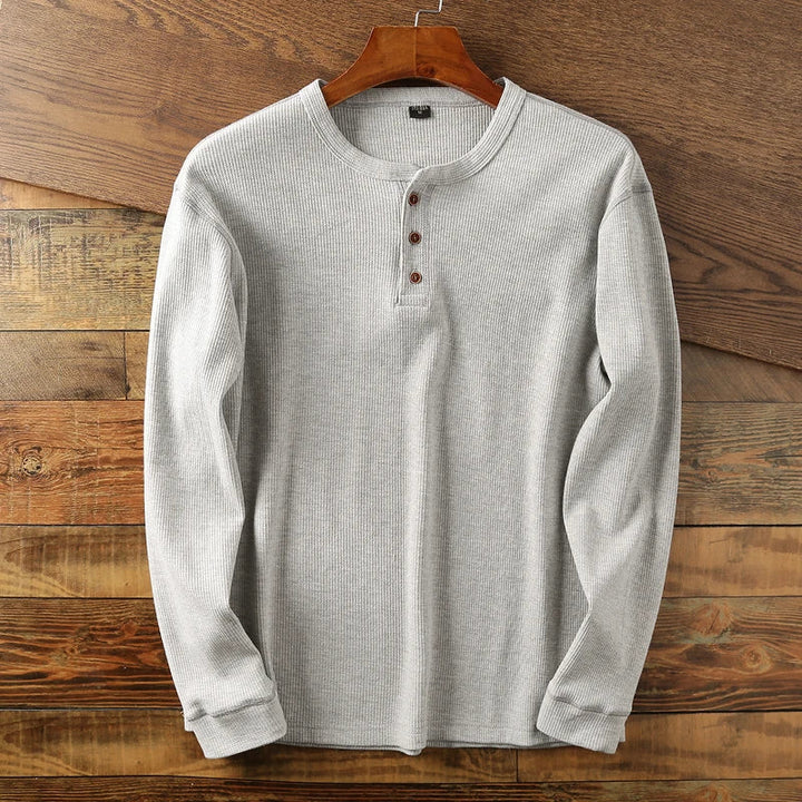 Stylish men's waffle knit long sleeve shirt for versatile layering, perfect for modern casual outfits.