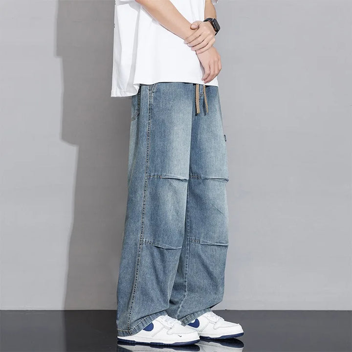 Fashionable men's washed wide-leg cargo jeans with deep pockets & drawstring waist for comfort.