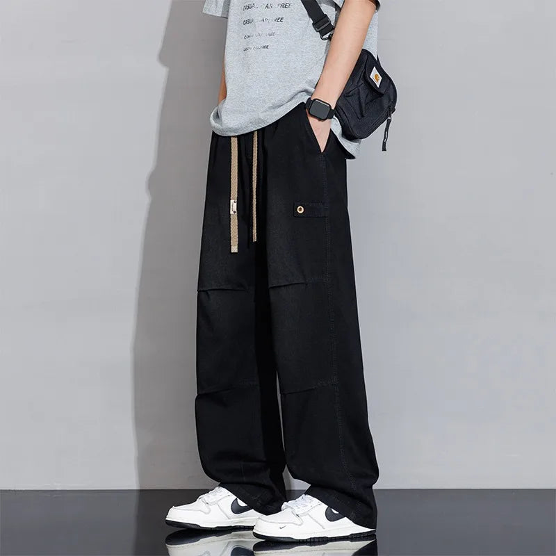 Stylish men's cargo jeans: washed denim, wide-leg cut, & functional pockets for modern streetwear.