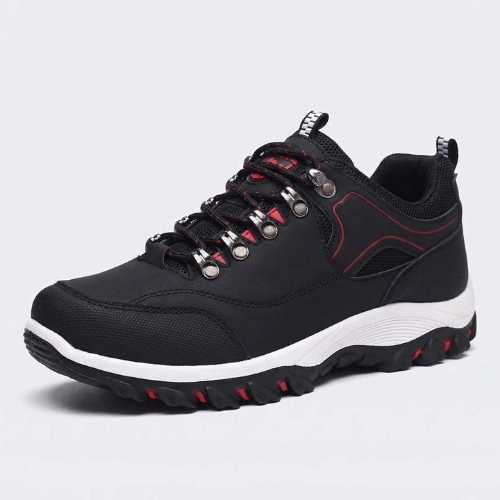 Close-up of waterproof material on men's low-cut hiking shoes, built for durable comfort on outdoor trails & adventures.