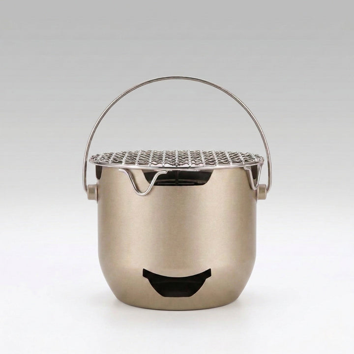 Mini cast iron charcoal grill, portable for camping and outdoor cooking, tabletop design for Korean BBQ.